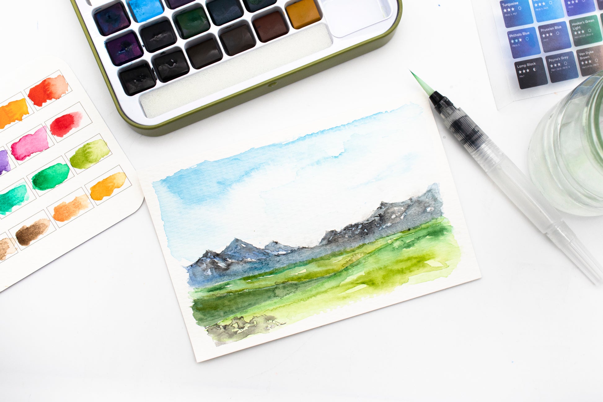 Artecho Aquarellfarben Set - 24 Farben, 1 Wassertankpinsel, 10 Blätter Aquarellpapier im Postkartenformat - SETL